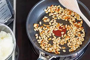 Pinienkerne ohne Öl in der Pfanne anrösten