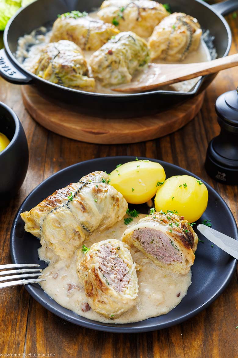 Deftige Kohlrouladen serviert mit Kartoffeln.