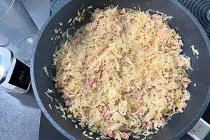 Gemüsebrühe hinzugeben und Sauerkraut köcheln lassen