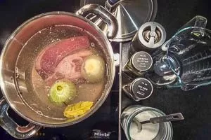Suppenfleisch und Zwiebel mit Wasser und Gewürzen aufkochen.