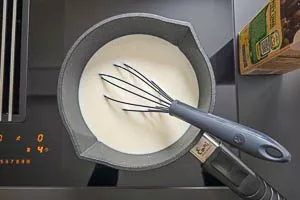 Milch im Topf erhitzen.