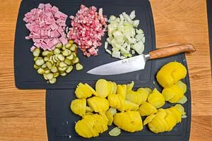 Gepellte Kartoffeln schälen und weitere Zutaten für das Bauernfrühstück schneiden