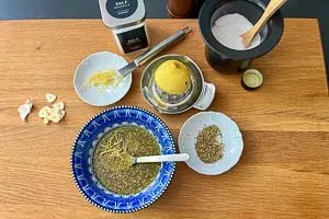 Marinade aus Zitrone, Öl, Kräutern und Gewürzen anmischen
