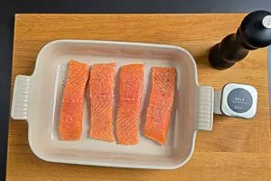 Lachs trocknen, mit Salz und Pfeffer würzen und in die Form legen