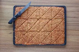 Den Teig für die Nussecken diagonal in Ecken schneiden.