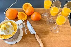 Orangen auspressen und Saft auf die Gl&auml;ser verteilen.