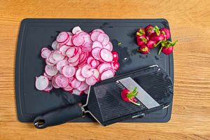 Radieschen waschen und in Scheiben hobeln