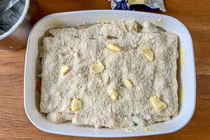 Die letzte Schicht besteht aus Parmesan, Butter und Bechamelsauce.