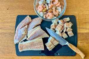 Meeresfrüchte bereitstellen, Fisch trockentupfen und in Würfel schneiden