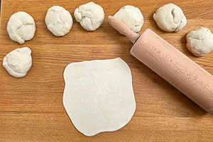 Teig-Kugeln zu Fladen ausrollen und ruhen lassen