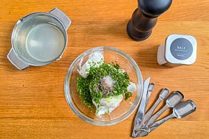 Minze, Zitronensaft, Oliven&ouml;l und Gew&uuml;rze hinzugeben